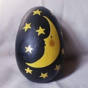 Black wooden oval egg painted with moon and stars